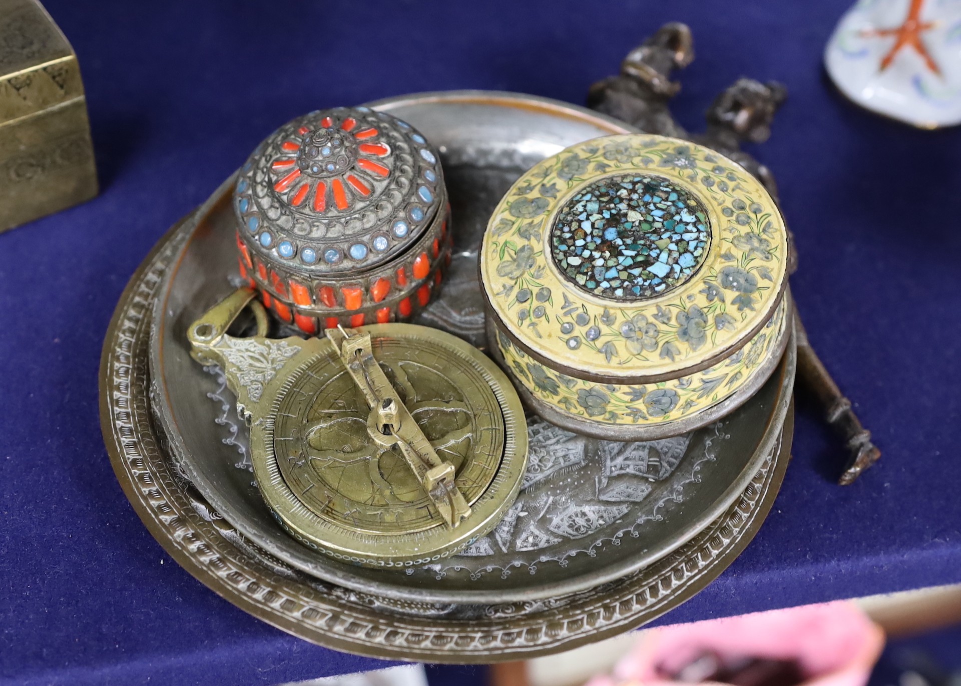 A group of Indian & Islamic items: an astrolobe, betel nut cutters, three bones and two dishes